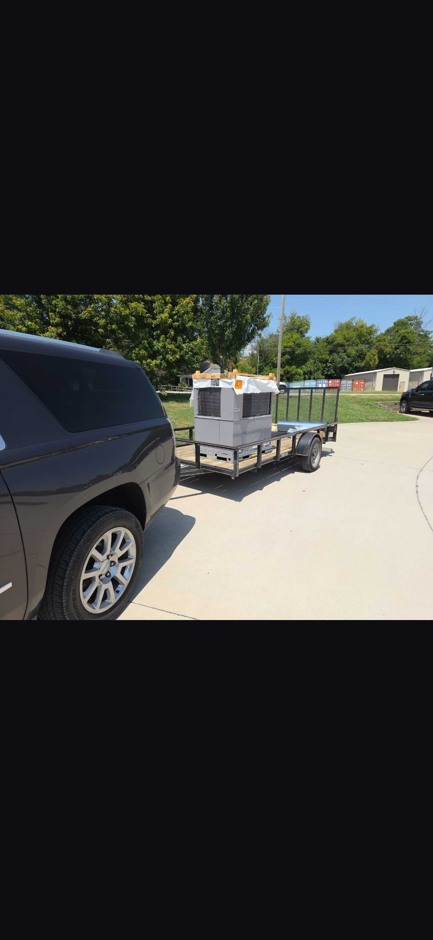 A packaged HVAC unit secured on a trailer for transport.