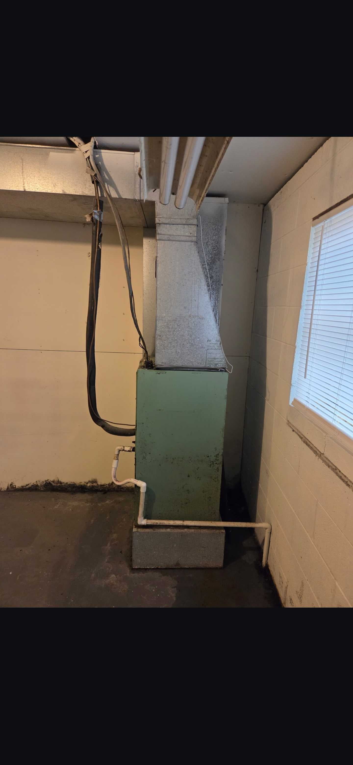 The existing equipment, ductwork, and drain connection from another angle.