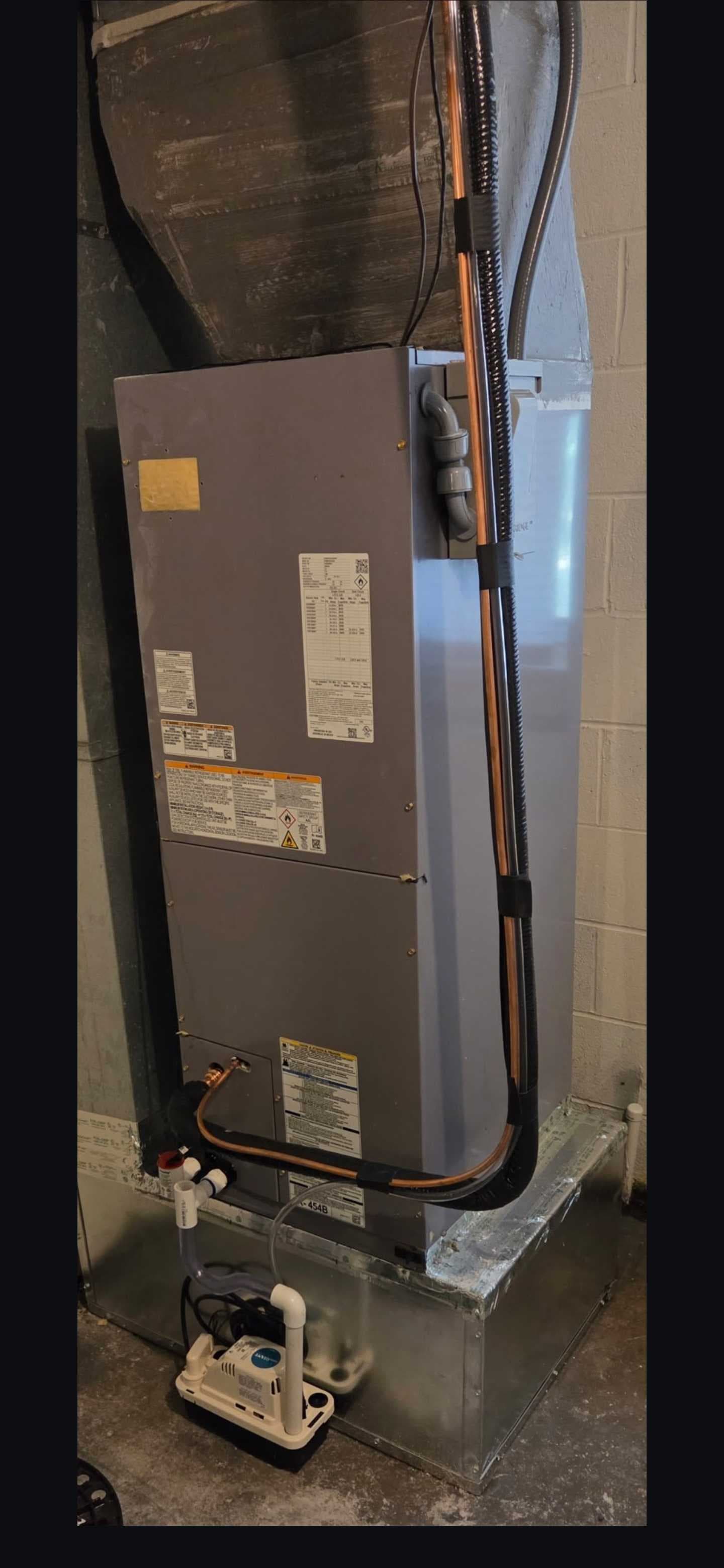 A closer look at the refrigerant lines, insulation, drainage, and condensate pump.
