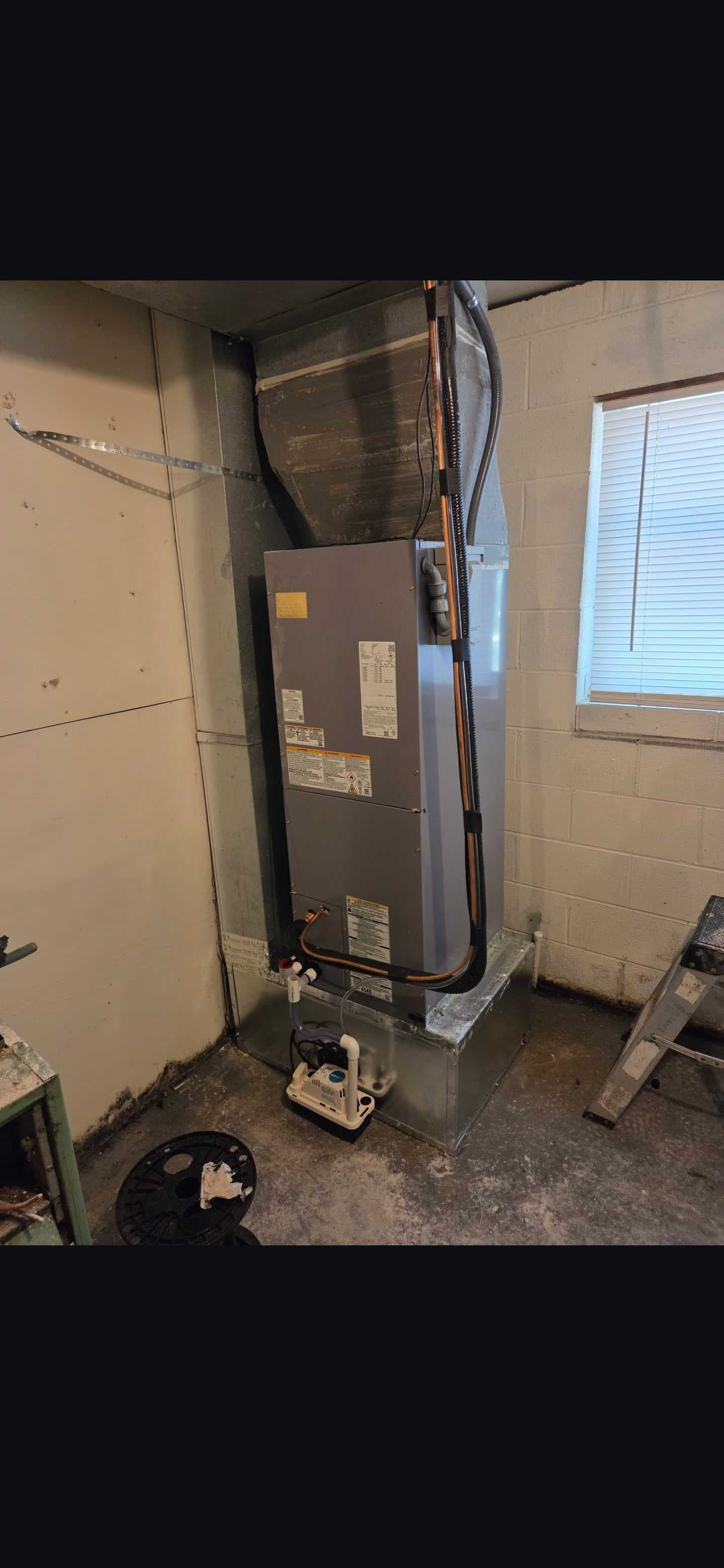 The replacement indoor unit with new refrigerant lines and condensate equipment visible.